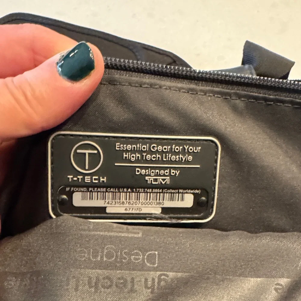 Tumi Black Messenger Bag excellent condition stay organized.
